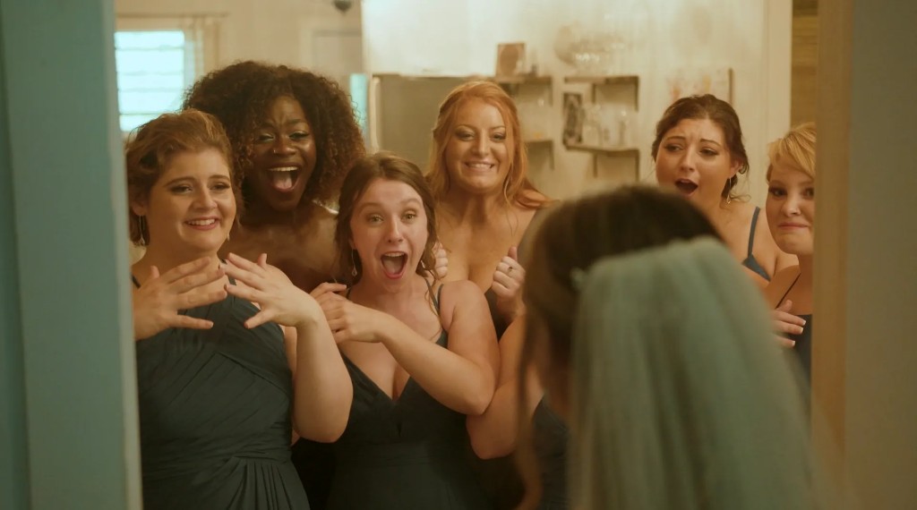 Bridesmaids react with joy during a first look with the bride